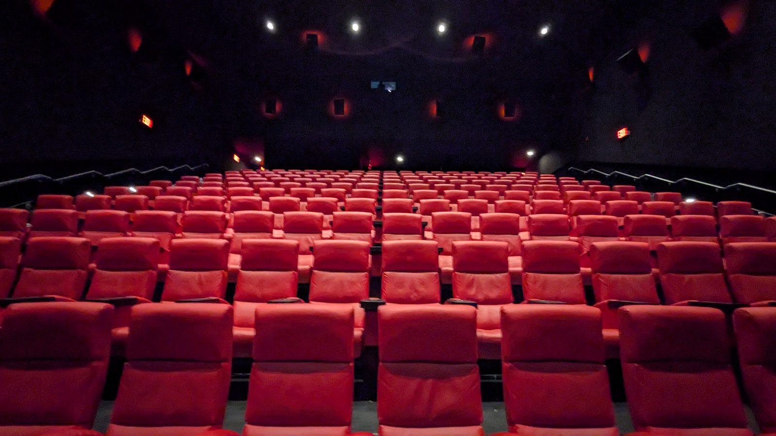 Rows of empty red seats in a movie theater