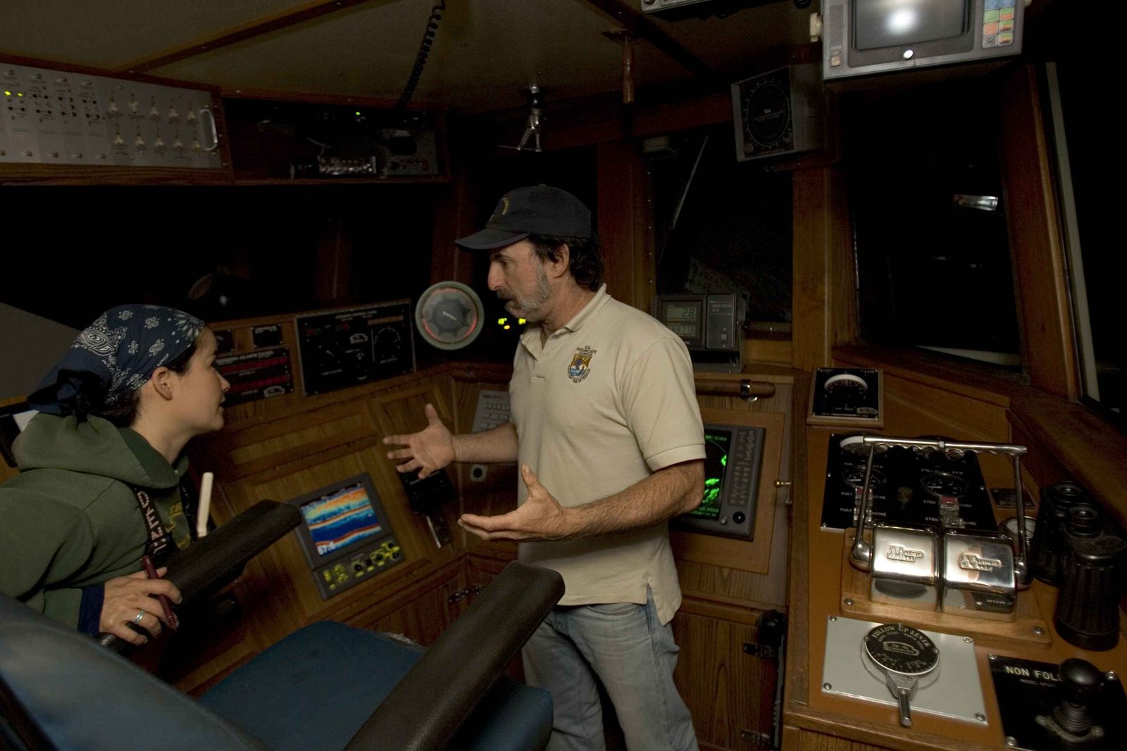 A man gesturing expressively while talking to a woman